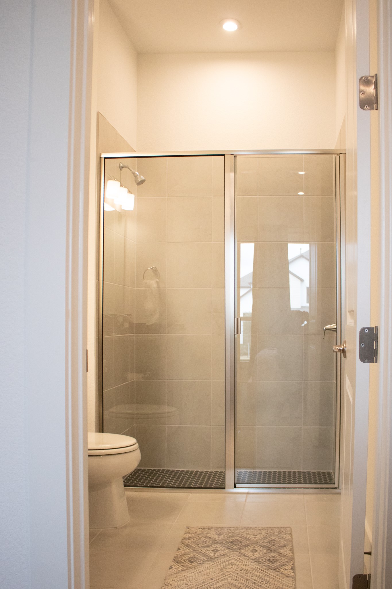 1709 Novara Trail Leander, TX 78641 - Photo 8 of 40 Bathroom featuring a shower stall, light tile patterned flooring, and recessed lighting