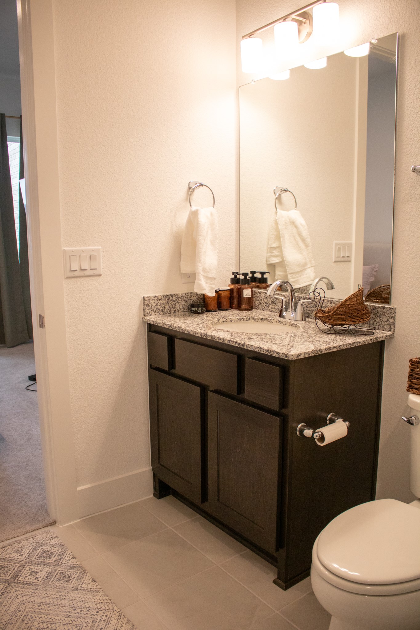 1709 Novara Trail Leander, TX 78641 - Photo 9 of 40 Half bathroom featuring vanity, a textured wall, and light tile patterned floors
