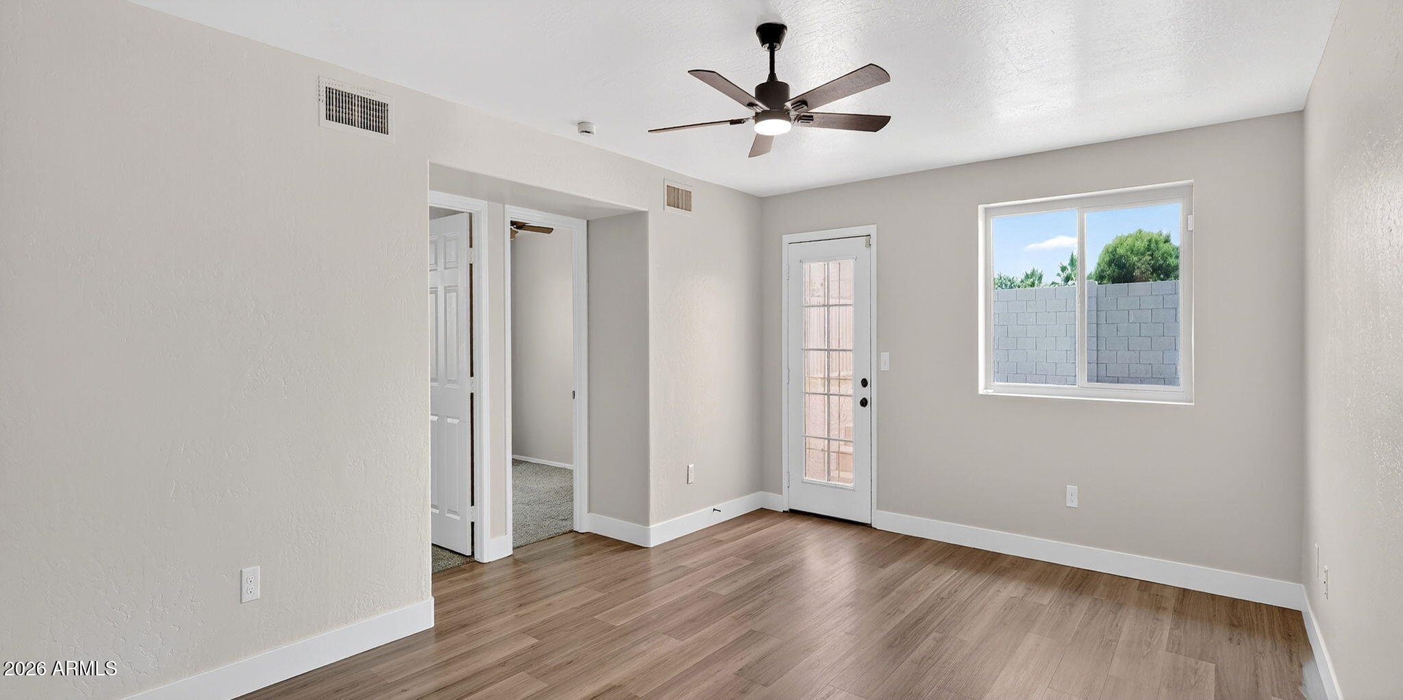 1417 East Mineral Road Gilbert, AZ 85234 - Photo 42 of 59 a view of an empty room with wooden floor and a window