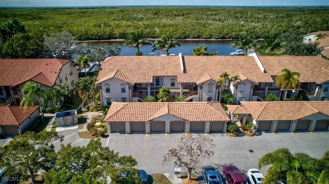 an aerial view of a house with a garden and lake view