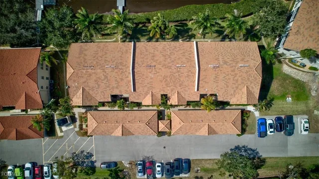 an aerial view of a house with swimming pool and outdoor seating
