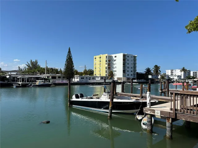 a view of a lake with boats and trees in the background
