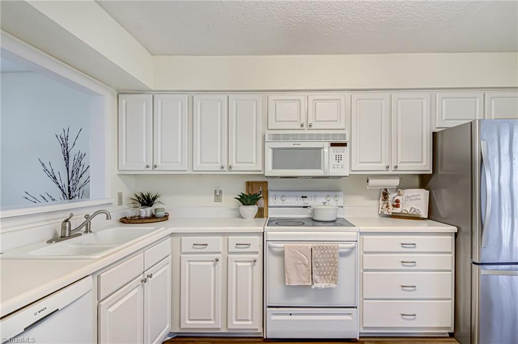 2640 Ingleside Drive, Unit 2D High Point, NC 27265 - Photo 11 of 27 Hardworking kitchen features double sink, dishwasher, built in microwave, and lots of cabinet and counterspace. Refrigerator remains!