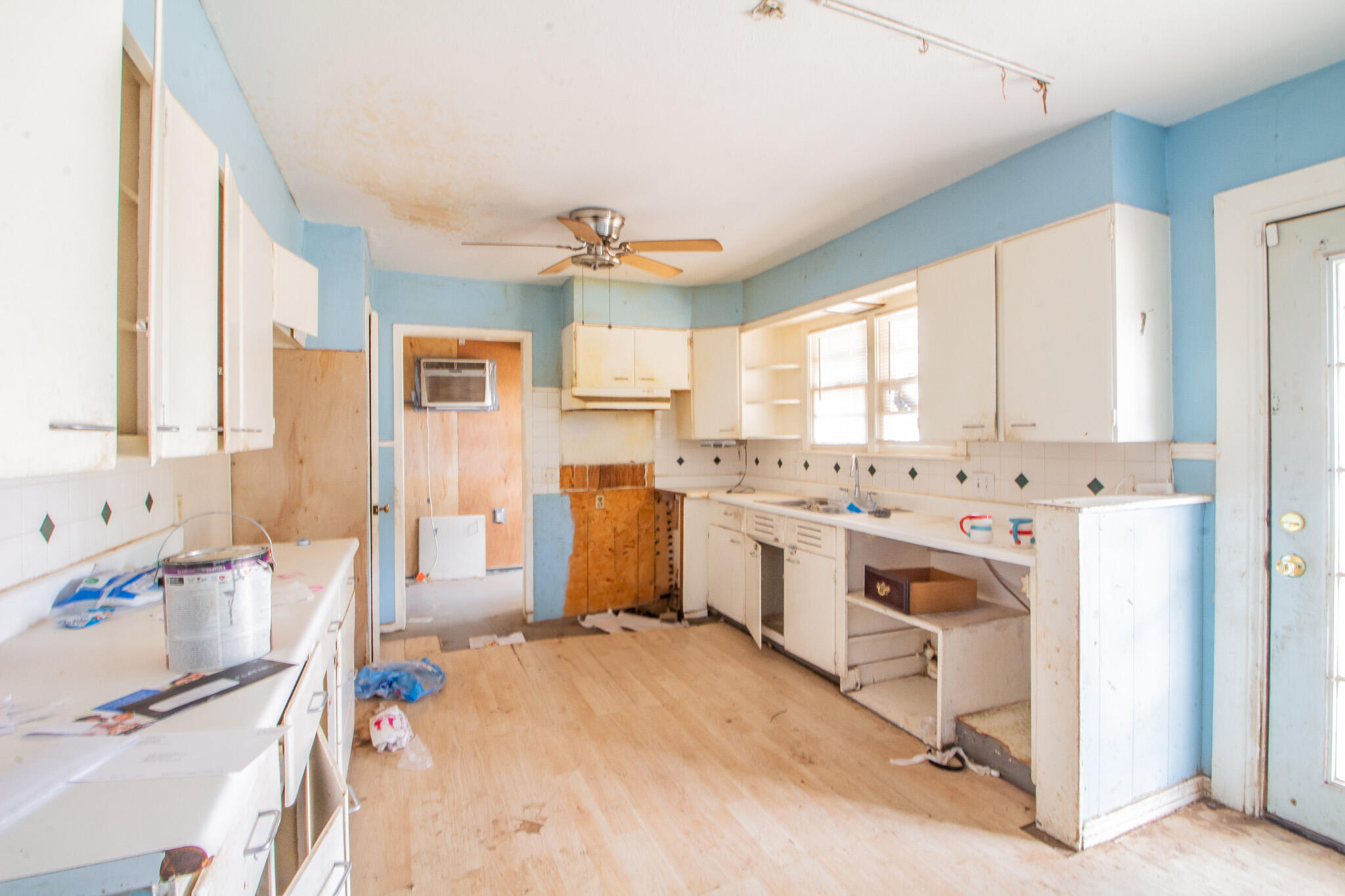 1606 60th Street Lubbock, TX 79412 - Photo 4 of 12 a kitchen with a sink stove and refrigerator