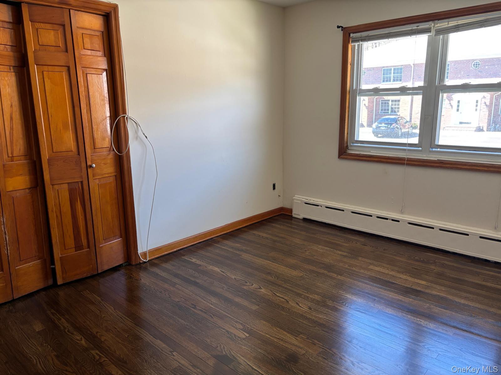 21 Highway 17, Unit 3 East Rutherford, NJ 07073 - Photo 10 of 13 Spare room featuring dark wood-type flooring and a baseboard radiator