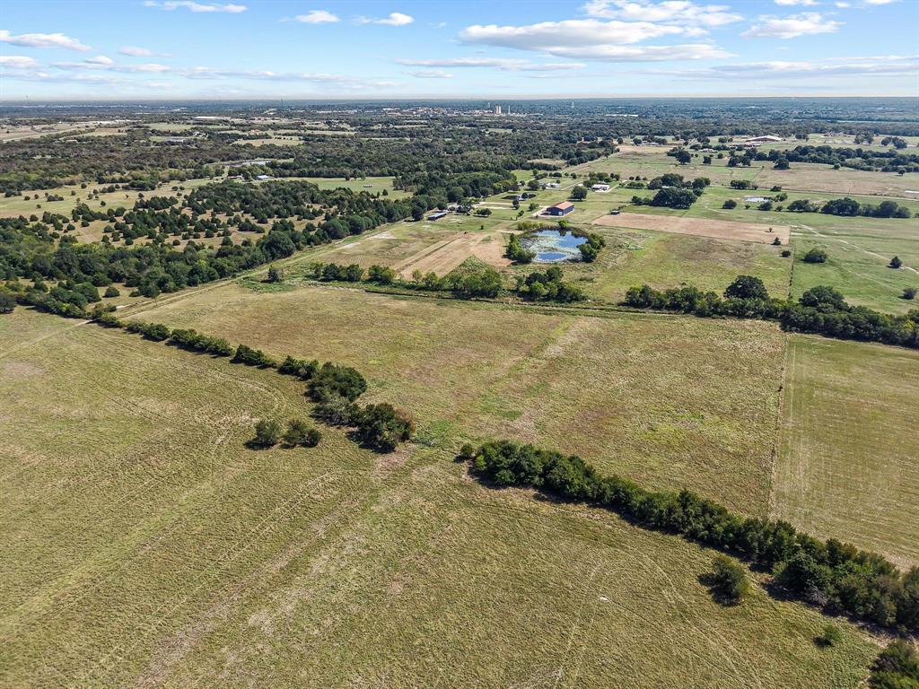 486 Private Road 4402 Commerce, TX 75428 - Photo 4 of 7 an aerial view of residential houses with outdoor space