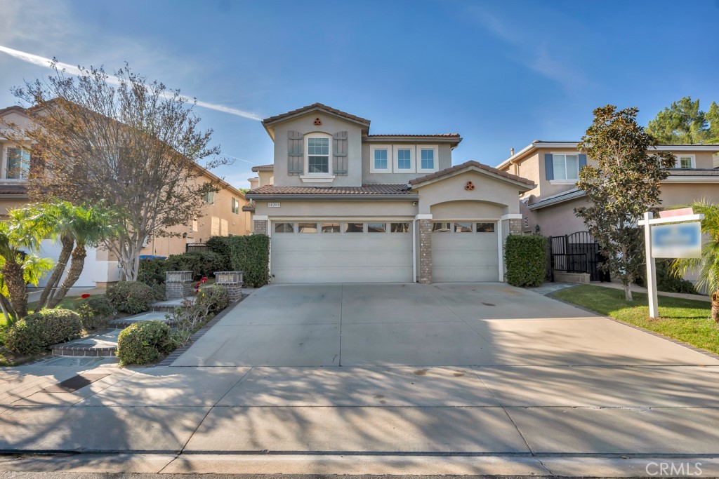 11205 Salerno Porter Ranch Porter Ranch, CA 91326 - Photo 3 of 43 a front view of a house with a yard