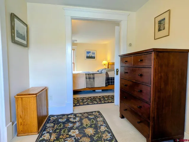 a bedroom with a bed and a dresser in it