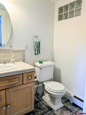 a bathroom with a sink a toilet and mirror