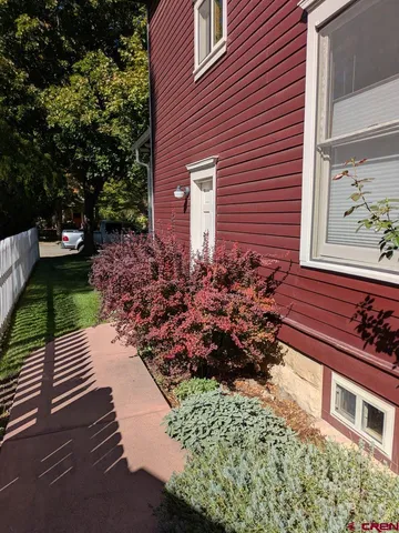 a view of a house with a yard and garden