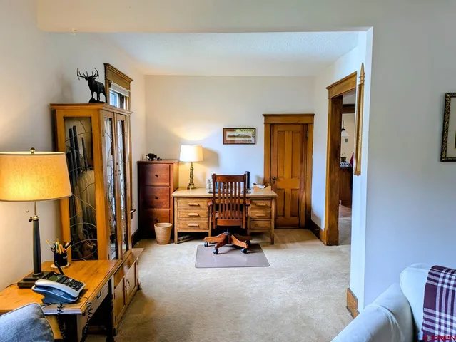 a view of a livingroom with furniture and a flat screen tv