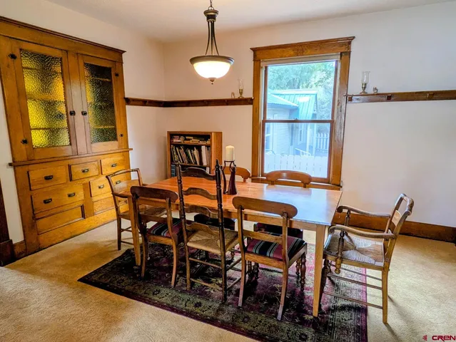 a dining room with furniture and window