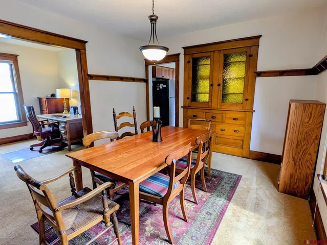 a dining room with furniture and window