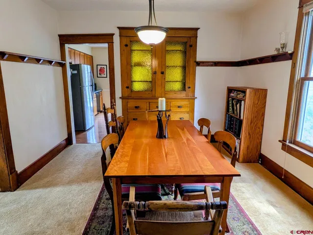 a dining room with furniture and a chandelier