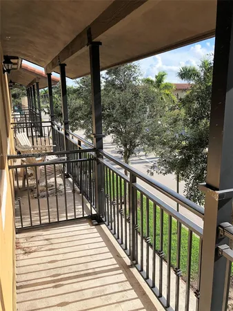 a view of a balcony with wooden floor