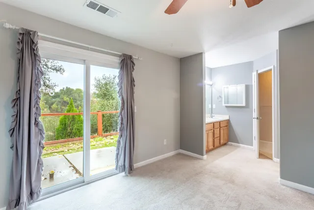 a view of an empty room and a swimming pool
