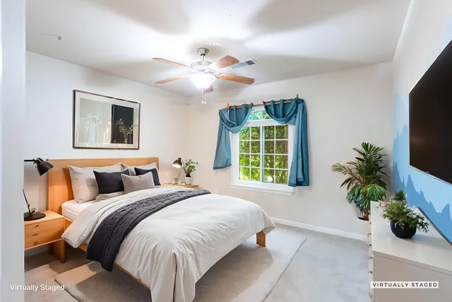 a bedroom with a large bed and a window