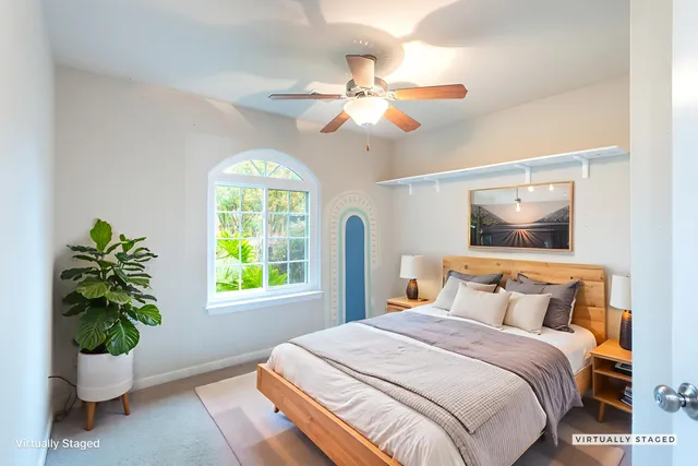 a bedroom with a bed and a window