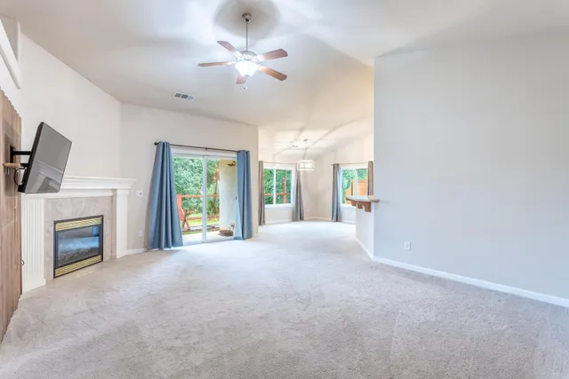 a view of a livingroom with an empty space and a fireplace