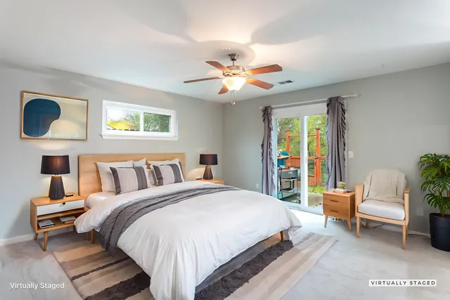 a spacious bedroom with a bed and a chandelier