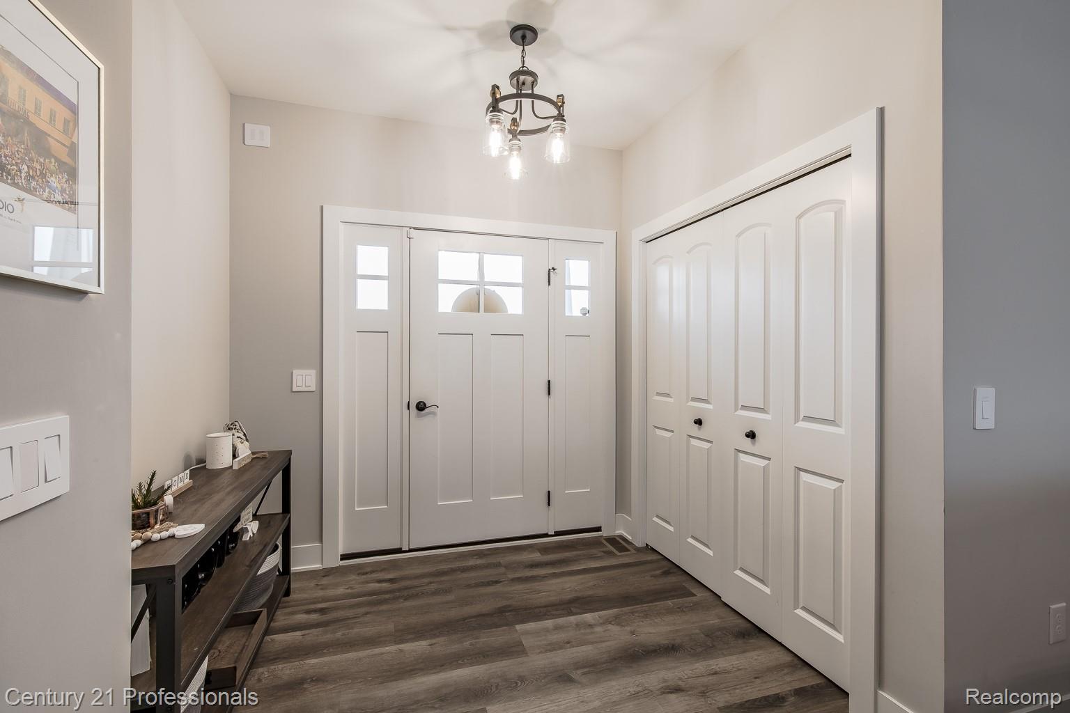 4914 TORATOLA Lane Howell, MI 48843 - Photo 7 of 39 Entrance foyer featuring dark wood-style flooring and hanging lights