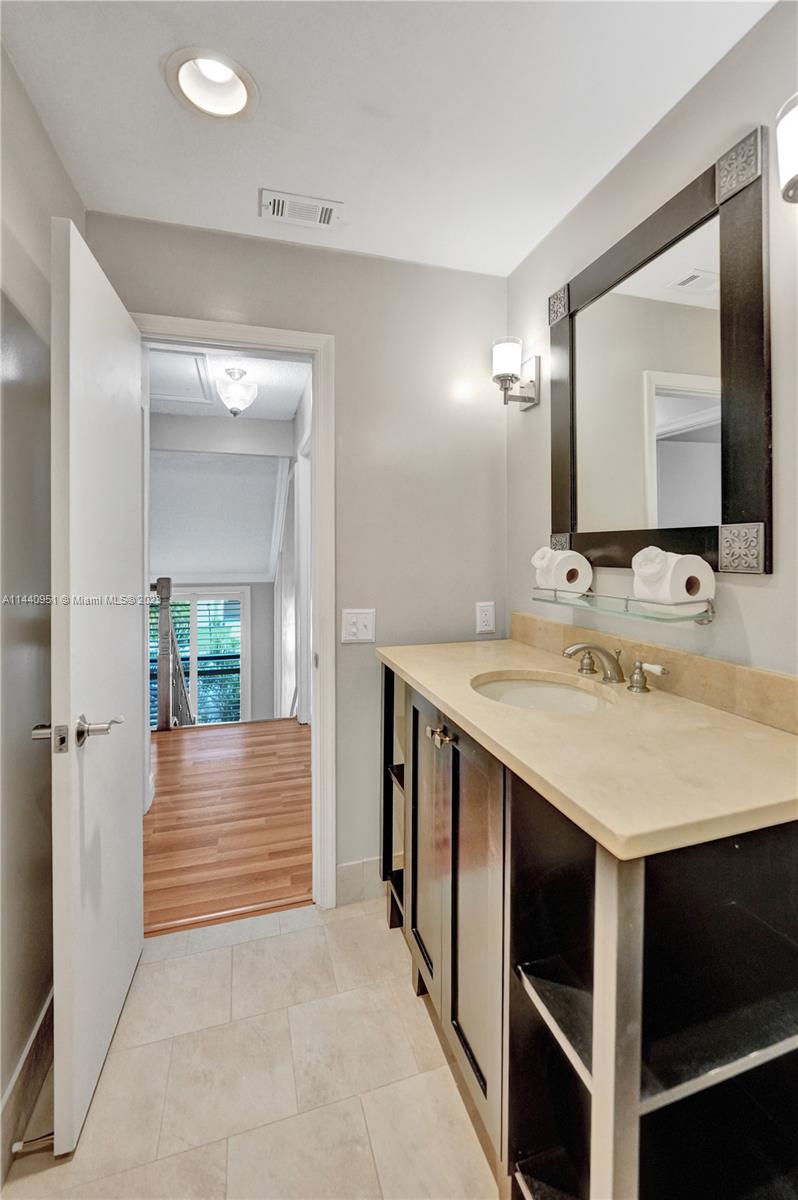 9338 Ketay Circle, Unit 4 Boca Raton, FL 33428 - Photo 54 of 81 a en suite bathroom with a sink and a mirror