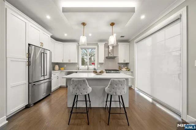 a large white kitchen with a stove and a refrigerator