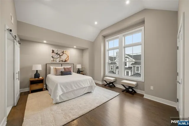 a bedroom with a bed and a lamp