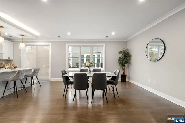 a view of a dining room with furniture and a potted plant