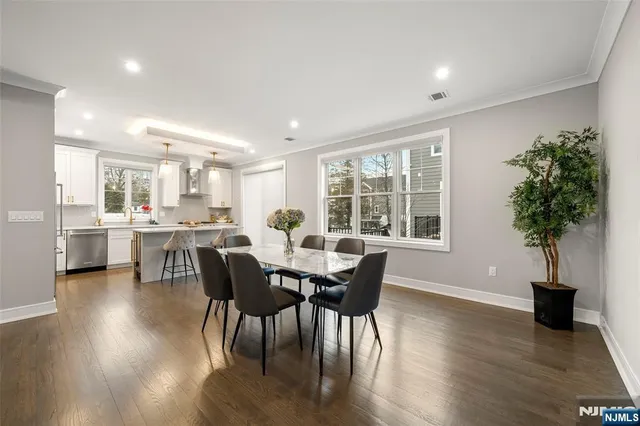 a view of a dining area with furniture and wooden floor