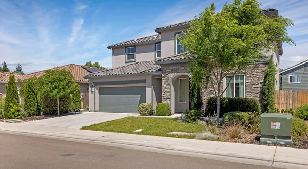 front view of a house next to a yard