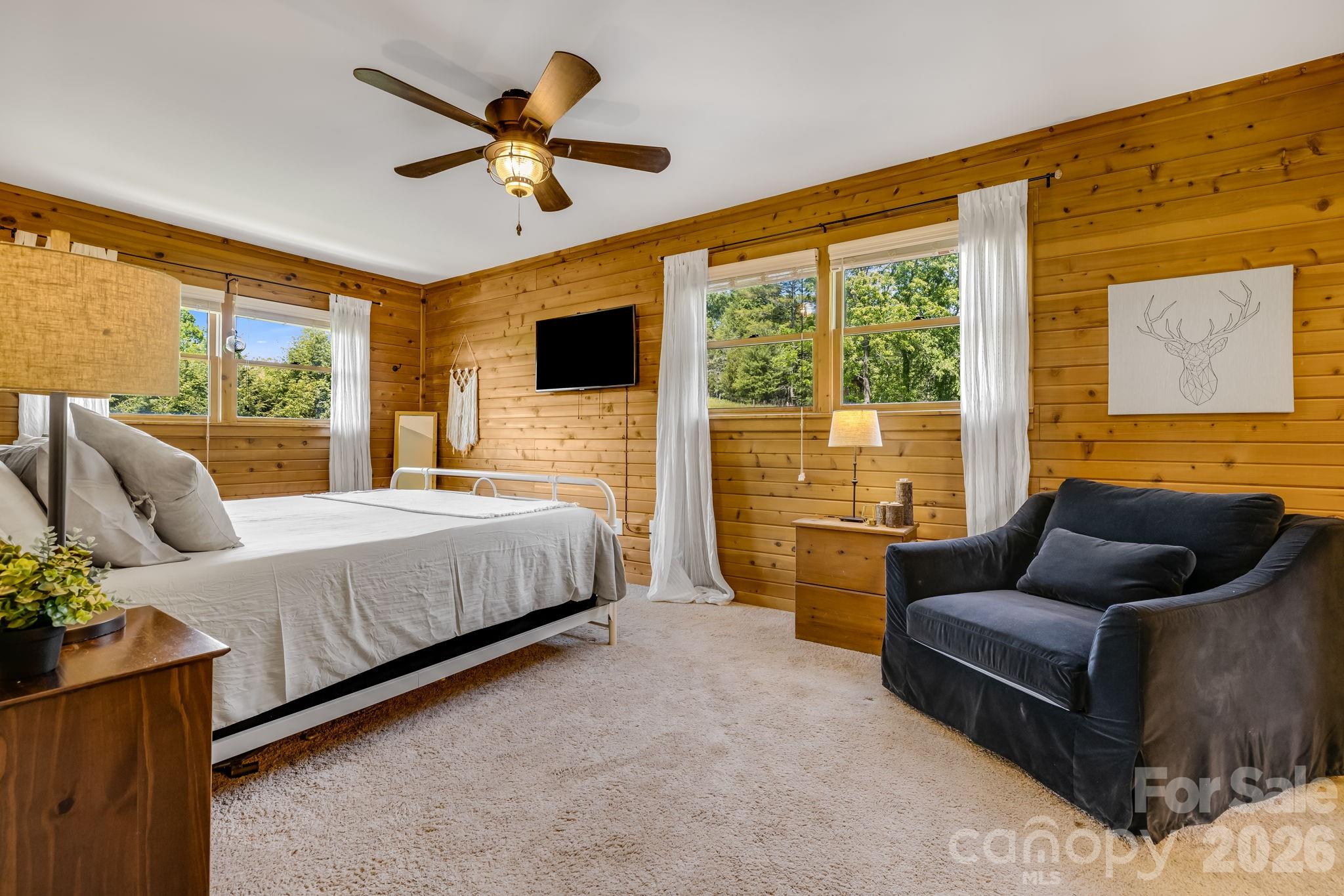 694 Boulder Road Marshall, NC 28753 - Photo 22 of 44 a bedroom with a bed and glass window