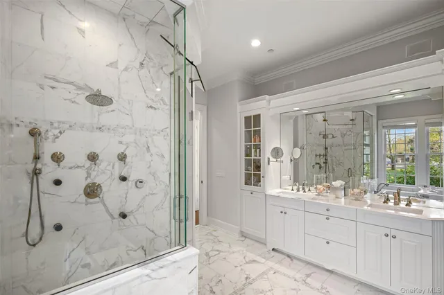 a bathroom with a double vanity sink mirror and shower