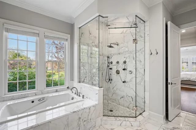 a bathroom with a granite countertop tub shower and sink