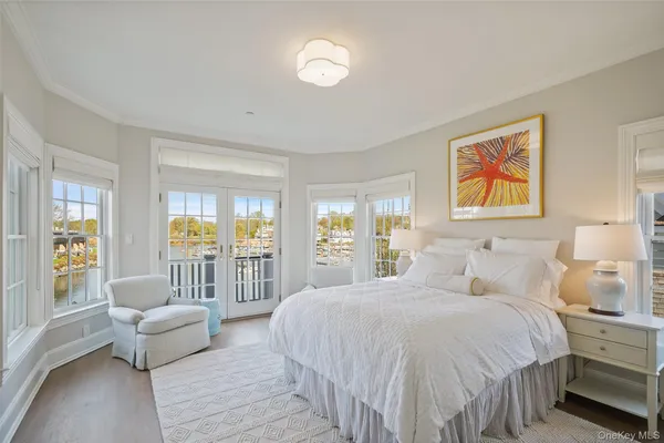 a large bedroom with a bed and glass window