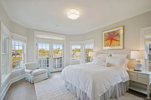 a large bedroom with a bed and glass window