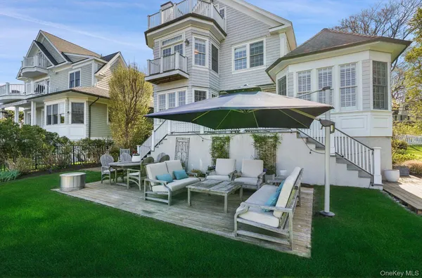 a view of a house with backyard sitting area and garden