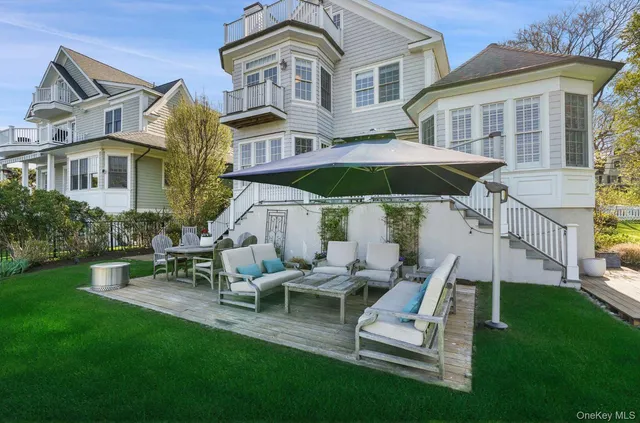 a view of a house with backyard sitting area and garden