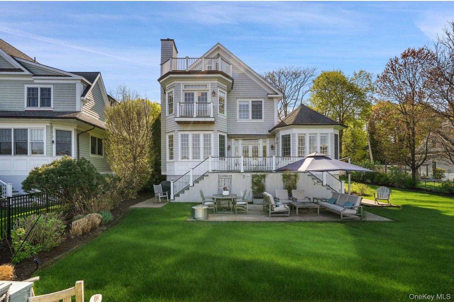 680 Milton Road Rye, NY 10580 - Photo 2 of 32 a front view of a house with a yard table and chairs