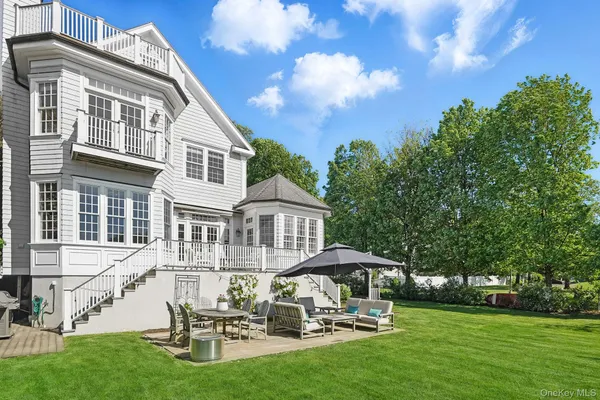 a swimming pool with outdoor seating and yard