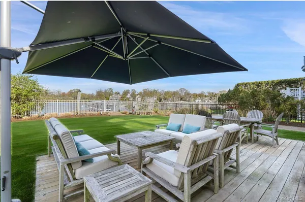 a view of a patio with furniture and a yard