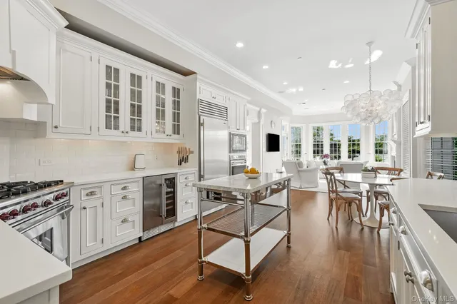 a open kitchen with stainless steel appliances granite countertop a stove and cabinets wooden floor
