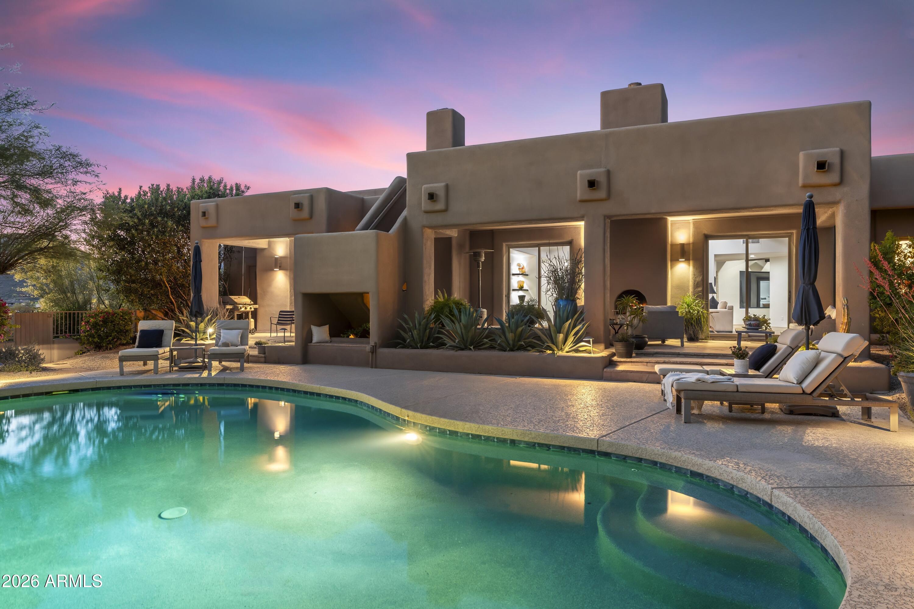 10046 East Hidden Valley Road Scottsdale, AZ 85262 - Photo 50 of 64 a view of a swimming pool with outdoor seating