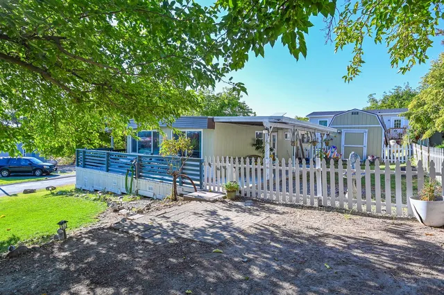 a view of a chair and table in the backyard