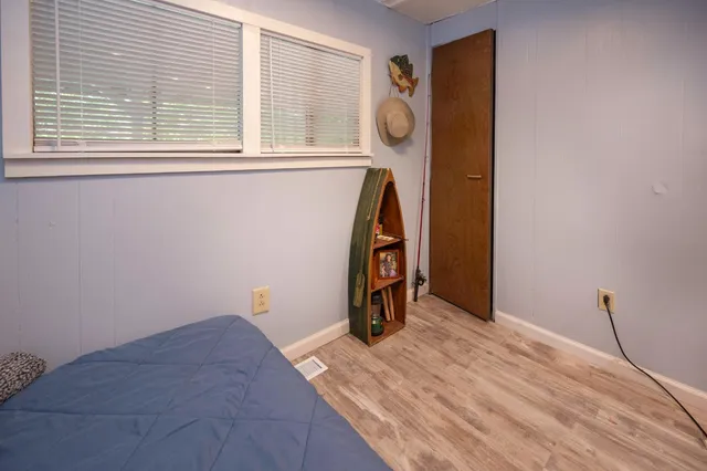 a bedroom with a large bed and a window