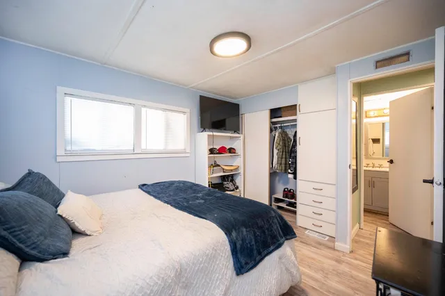 a bedroom with a bed and a window