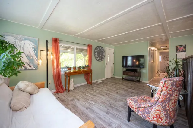a wooden bench sitting in front of a house