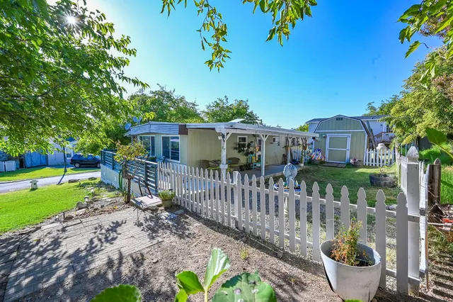 a view of a house with a yard and a garden