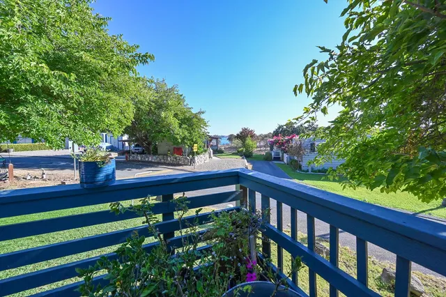 a view of a porch with furniture and garden