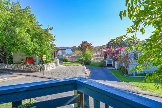 a backyard of a house with wooden floor and outdoor seating